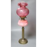 A Victorian brass and pink glass oil lamp, height 70cm