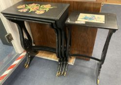 A graduating nest of four Regency style occasional tables with lyre shaped supports, black painted