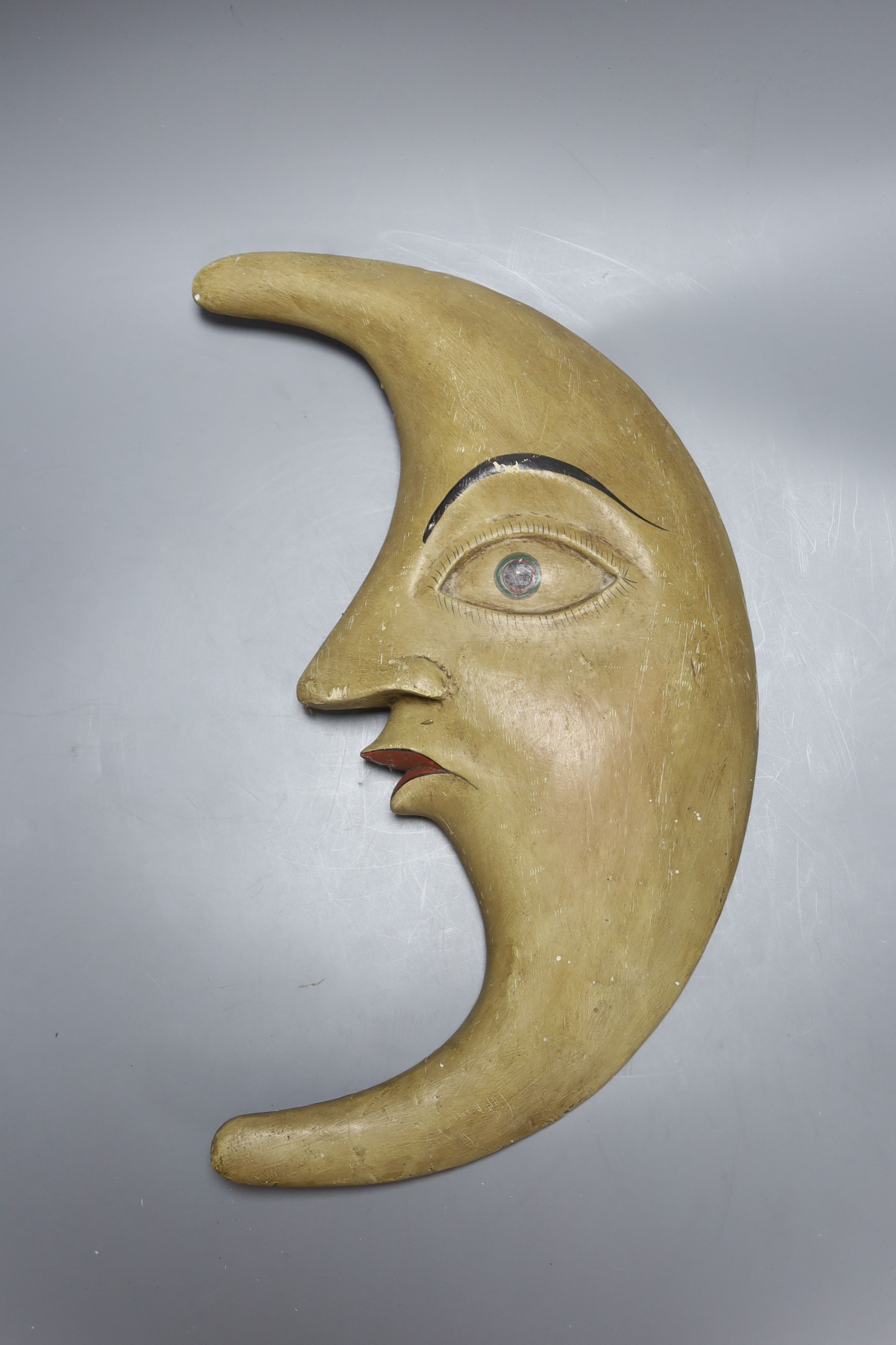 A Continental printed wood crescent 'Man in the Moon' plaque, back inscribed CWL 1910 MAYEN