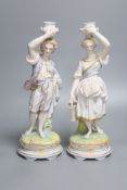 A pair of French export bisque porcelain figural candlesticks, stamped Chantilly, height 34cm (one