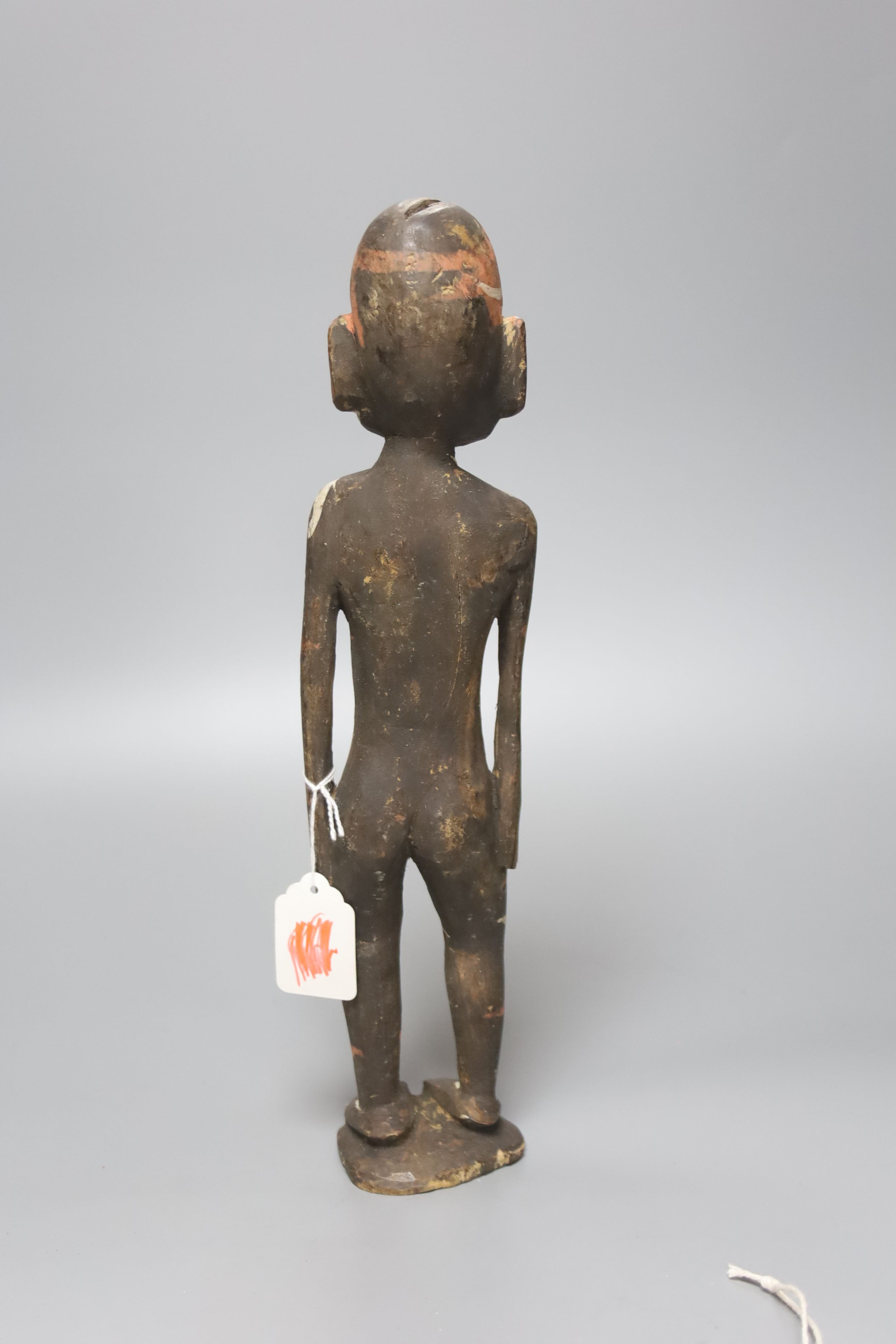 A Papua New Guinea wood figure, painted in coloured pigments, height 34cm