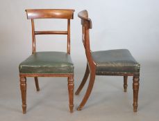 A set of eight William IV mahogany dining chairs, with curved cresting rails and spars, green fabric