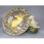 A vintage Whitbread & Company oval plaque, length 33cm, and a painted 'goose' door stop