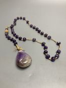 An amethyst bead necklace with amethyst pebble pendant.
