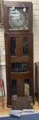 A large and unusual 20th century oak cased longcase clock, in the arts and crafts style,