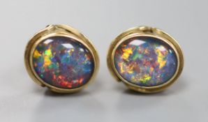 A pair of yellow metal and simulated opal set oval ear studs, 11mm, gross 2.6 grams.