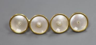 A pair of yellow metal(stamped 18), mother of pearl and seed pearl set disc cufflinks( 2 pearls