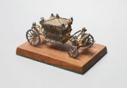 A 1970's miniature silver model of the Coronation coach, London, 1977, 75mm, fixed on a wooden base,
