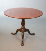 A George III mahogany tea table, with tilting circular top on birdcage stem and tripod base, Diam.