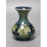 A Moorcroft green and blue leaf and berry vase, height 13cm