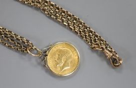 A George V 1912 gold sovereign, in 9ct gold pendant mount, on an Edwardian 9c double link chain,
