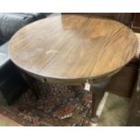 A 1920's circular mahogany extending dining table with three leaves and handle, length approx. 230cm