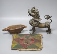 A South East Asian brass Buddhistic lion, carved wood vessel and an African tribal beaded pouch