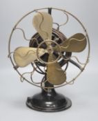 A vintage cast iron and brass propeller desk fan, height 42cm
