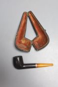 A cased pipe with amber mouthpiece and 9ct gold collar.