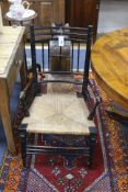 A Liberty & Co ‘Argyll’ model elbow chair, circa 1890, width 51cm, height 91cm.