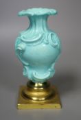 A Chelsea Derby rare rococo moulded vase with celadon type ground, mount on a gilt metal base,