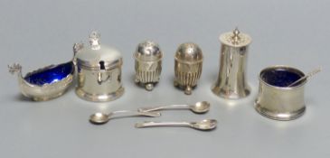 A collection of silver condiments, including a Norwegian 'Viking' longboat salt, a cylindrical