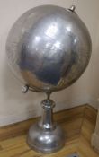 A large polished metal stylised celestial globe, retailed by Andrew Martin, H approx 110cm