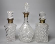 Three silver mounted glass decanters, tallest 32cm including stopper