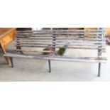 A slatted wood garden bench marked L M Furniture (in need of repair), length 244cm, depth 70cm,
