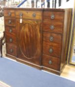 A George III line-inlaid mahogany breakfront side cabinet, fitted with an arrangement of eight short