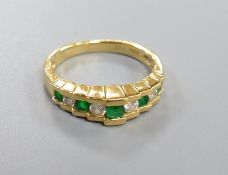 An Art Deco style emerald and diamond nine-stone ring in stepped setting, stamped 14K, size K, gross