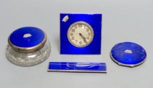 A 1930's four piece silver and blue enamel dressing table set, including , timepiece, powder jar,