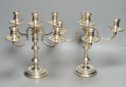A pair of Georgian style silver four-branch five-light candelabra, Makers William Comyns & Sons Ltd,