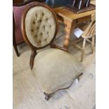 A Victorian walnut spoonback nursing chair