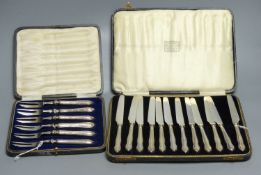 A cased set of twelve silver-handled dessert knives and a cased set of six similar cake forks (