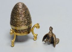 A modern silver gilt surprise egg, by Richard Lawrence Geere, London, 1975, on stand & a modern