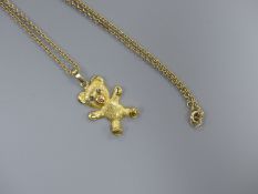 A modern 9ct gold and gem set teddy bear pendant, 26mm, on a 9ct chain, 41cm, gross 6 grams.