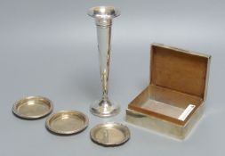 An engine-turned silver cigarette box, a pair of circular pin dishes, another pin dish and a