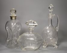 A George V silver collared decanter, a facet cut glass decanter and a wheel engraved glass claret