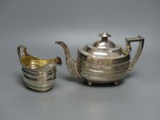 A George III silver teapot and matching cream jug, Urquhart & Hart, London, 1805/1807, gross 23oz.