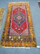 A Caucasian polychrome geometric rug, 200 x 100cm