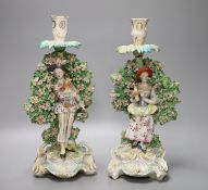 A pair of Derby bocage figural candlesticks, of the Italian farmer and his wife, c.1770, height 31.