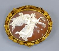 A Victorian pinchbeck mounted oval cameo shell brooch, with fruiting vine border and carved with