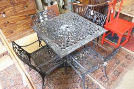 A Victorian style square cast metal garden table, width 88cm, height 72cm and four elbow chairs (one