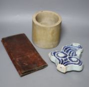 A Chinese blue and white Ming porcelain finial, a leather wallet. c.1920 and a cream stone cylinder,