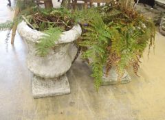 A pair of reconstituted stone campana garden urns on stands, diameter 36cm, height 45cm