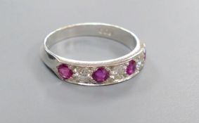 A modern 18ct white gold, four stone ruby and three stone diamond set half hoop ring, size M,