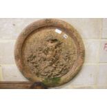 A circular terracotta garden wall plaque, diameter 62cm