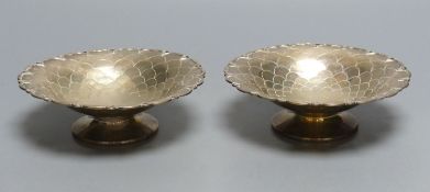 A pair of circular silver sweetmeat tazzas each having scale decoration, shaped rim and circular