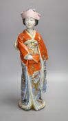 A large Japanese enamelled porcelain figure of a Geisha, early 20th century, height 46cm