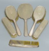 A six-piece engine-turned silver-mounted dressing table set, comprising two pairs of brushes, a comb