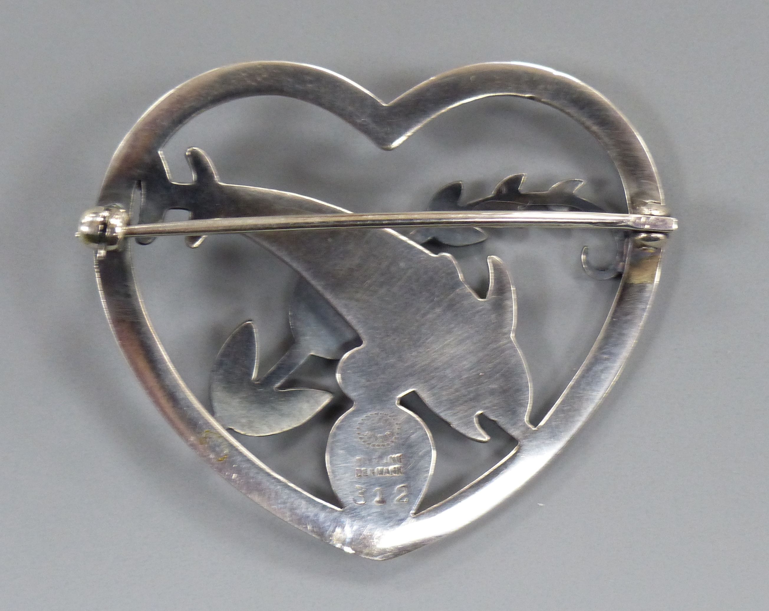 A Georg Jensen sterling heart shaped brooch, depicting twin leaping dolphins with frond, no. 312, - Image 2 of 2