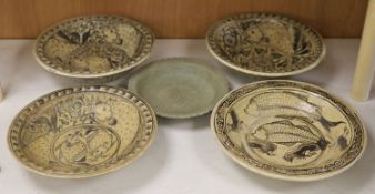 Four Sukhothai style dishes and a Thai celadon dish, diameter 32cm