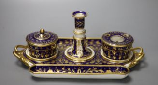 A Derby inkstand ornately gilded on a cobalt blue ground having a sander and cover, inkpot and taper